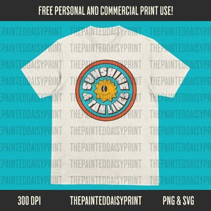 May include: A white t-shirt with a colorful graphic design of a sun with the text "Sunshine & Vitamin Sea".