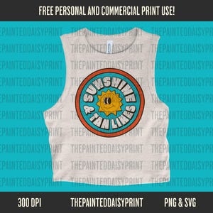 May include: A white tank top with a colorful graphic design featuring a sun with a smiley face and the text "Sunshine & Tan Lines".