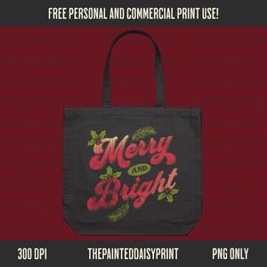 May include: Black tote bag with the words "Merry and Bright" in red and white script, decorated with holly and pine branches. The bag has a simple design with a rectangular shape and two handles. The text "FREE PERSONAL AND COMMERCIAL PRINT USE!" is at the top.