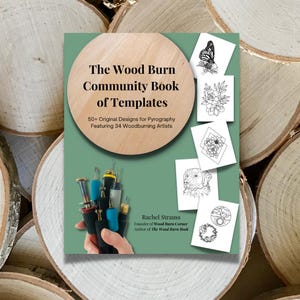 May include: A green book cover with a wood-grain background and the title "The Wood Burn Community Book of Templates". The book features 50+ original designs for pyrography and includes work from 34 woodburning artists. The cover also includes a photo of a hand holding a set of woodburning tools.