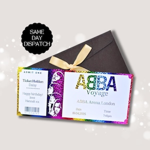 May include: A rectangular souvenir ticket for an ABBA Voyage concert at the ABBA Arena in London on 19.04.2025 at 7:45pm. The ticket features a rainbow glitter border, a black and white portrait of the band, and a barcode labelled SURPRISE.
