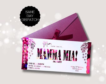 May include: A white rectangular ticket with pink and black floral accents and the text Mum, you're going to Mamma Mia! The Party, The O2, London, Saturday 13 June 2026, 6:30PM, Happy 70th Birthday Dancing Queen. A dark pink envelope sits behind it.