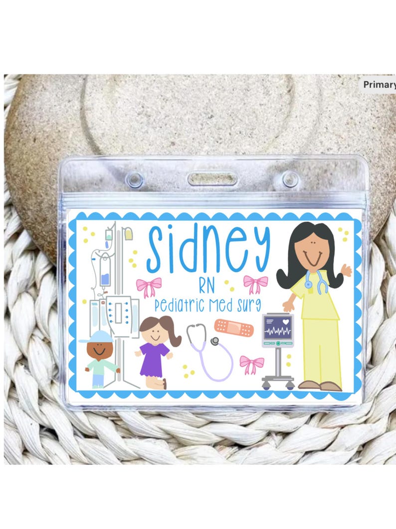 May include: A clear plastic name badge with a blue scalloped border. The badge features the name "Sidney" in blue script, along with illustrations of medical equipment and a nurse. Text on the badge reads "RN Pediatric Med Surg".