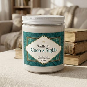 May include: A cylindrical glass candle jar with a white lid, filled with off-white wax. The label features a teal geometric pattern, a white diamond-shaped center, and the text: Smells like Coco's Sigils, Camille's Fields, Premium Soy Wax, 50 Hours.