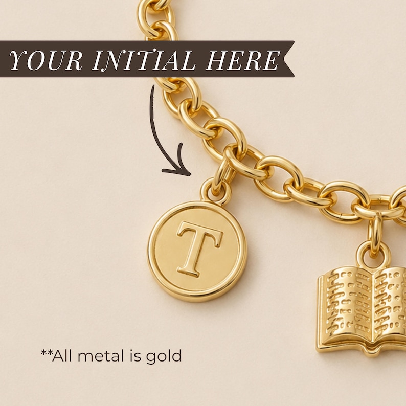 May include: A gold-toned chain bracelet featuring two dangling charms. One charm is a circular disc embossed with the letter T, and the other charm is a small, open book. The text YOUR INITIAL HERE and **All metal is gold are visible.
