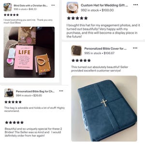 May include: A dark blue, rectangular, zippered Bible cover featuring a centered silver-toned cross emblem on the front panel. The cover has a smooth, matte texture and a structured design, providing a protective case for a book or Bible.