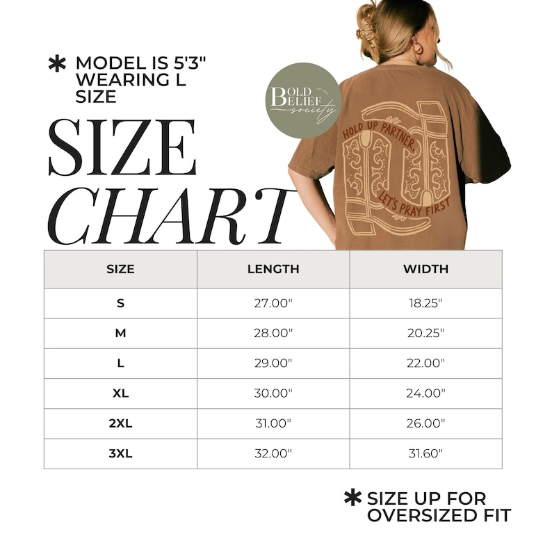 May include: A size chart for a brown t-shirt with the text "Hold Up Partner, Let's Pray First". The chart shows measurements for sizes S to 3XL, with lengths from 27.00" to 32.00" and widths from 18.25" to 31.60". The model is 5'3" and wearing a size L.