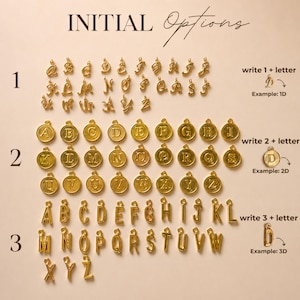 May include: A collection of gold-colored metal letter charms organized into three distinct styles. Row 1 features cursive script letters, row 2 displays letters on circular discs, and row 3 shows block-style letters. Text labels indicate options 1, 2, and 3.