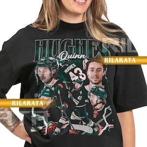 May include: Black adult unisex t-shirt featuring a collage of hockey player images and the name "Hughes" in a green and white design. The number "43" is prominent. The text "Quinn" is also visible. The shirt includes the text "Rilarata" and "Ready Custom Designs".