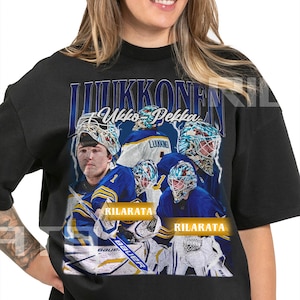 Könnte beinhalten: Schwarzes Unisex-T-Shirt für Erwachsene mit einer Grafik von Ukko-Pekka Luukkonen, einem Eishockeyspieler. Das Design enthält den Namen des Spielers, die Teamfarben und das Wort "RILARATA". Das Shirt hat einen Rundhalsausschnitt und kurze Ärmel.