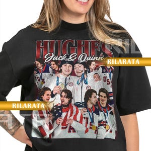 May include: Black adult unisex t-shirt featuring a graphic of hockey players with the text "HUGHES Jack & Quinn". The image includes the text "US" and "RILARATA". The shirt is a ready custom design.