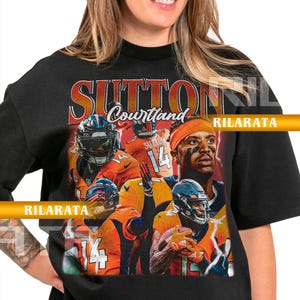May include: Black adult unisex t-shirt featuring a graphic of a football player with the name "Sutton" and the number "14". The design includes the text "Courtland" and "Rilarata". The shirt is a ready custom design.
