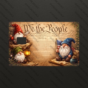 May include: A decorative card featuring three gnomes with white beards and pointed hats. One gnome holds an American flag. The card has the text "We the People" on a parchment-like background. The card is decorated with the words "STATELINE DECALS".