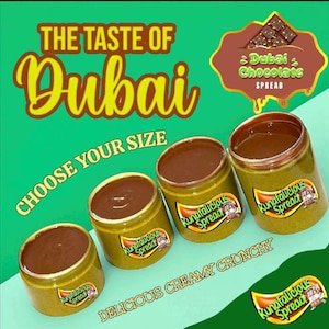 May include: Four jars of Kunatalicious Dubai Chocolate Spread. The jars are gold with a brown spread inside. Text on the image reads "The Taste of Dubai", "Choose Your Size", and "Delicious Creamy Crunchy". A graphic shows chocolate.