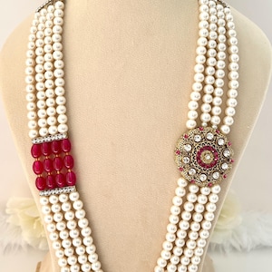 May include: A white ceramic mug with a black handle and the text "But First, Coffee" in a black, handwritten-style font. The mug is on a white surface.