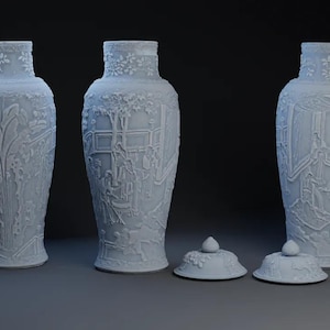 May include: Three light blue decorative vases with lids. The vases have detailed relief patterns of foliage and figures. The lids are round with a small knob on top. The vases are a classic home decor item.
