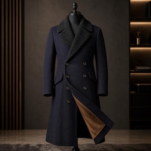 May include: A double-breasted navy blue overcoat featuring a textured black shearling collar and a warm brown interior lining. The coat is displayed on a mannequin and includes two rows of dark buttons, long sleeves, and two side flap pockets.