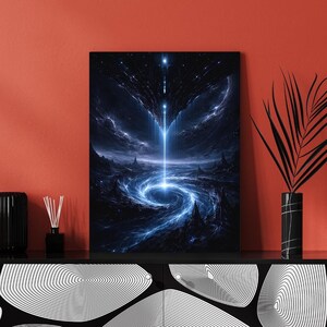 May include: A framed canvas print depicting a cosmic scene with a bright blue light emanating from above, forming a swirling vortex. The artwork features dark blues and blacks, with hints of white, creating a dramatic and otherworldly landscape.
