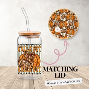 May include: A clear glass tumbler with a bamboo lid and straw, featuring the text "FALLS OUT BALLS OUT" with pumpkin and football graphics. A matching lid with a pumpkin pattern is also shown. The text "MATCHING LID" is displayed.
