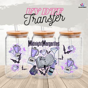 May include: Three clear glass drink tumblers with bamboo lids and straws. Each tumbler features a "Midnight Margaritas" design with purple and black graphics of cocktail ingredients, bats, and a spiderweb. The text "UV DTF Transfer" is at the top.