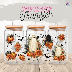 May include: Three glass tumblers with bamboo lids and straws, decorated with Halloween-themed designs. Each tumbler features pumpkins, bats, spiderwebs, and a ghost or black cat. The text "UV DTF Transfer" is at the top.