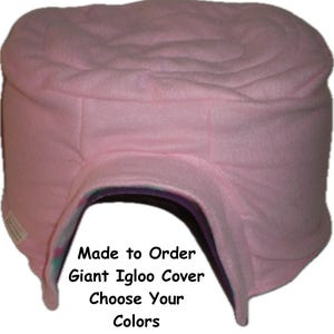 May include: Pink fleece igloo cover for a pet bed. The cover has a large opening for the pet to enter and exit. The text on the cover reads "Made to Order Giant Igloo Cover Choose Your Colors".