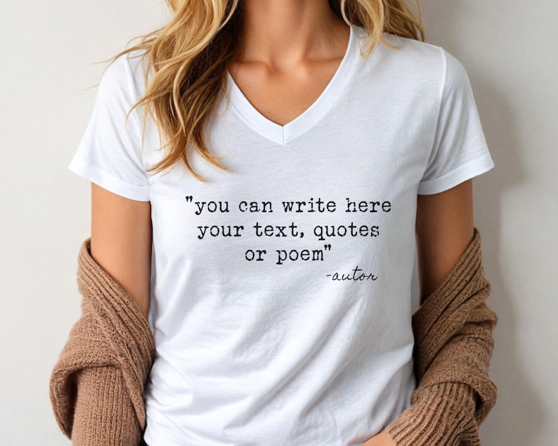 May include: A white V-neck t-shirt featuring black typewriter-style text that reads, "you can write here your text, quotes or poem" followed by "-autor" in a cursive script font. The shirt is worn with a brown knit cardigan draped over the shoulders.