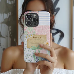 May include: A multi-patterned phone case featuring floral, striped, and paisley designs in pastel colors. The case includes the text "Jhon 3.16" and a quote. A green ribbon and daisy accents add detail to the design.