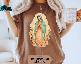 May include: Espresso-colored t-shirt featuring a religious illustration of a woman in a blue and peach gown, surrounded by a golden halo and roses. The shirt has the words "COLOR espresso SIZE: XL" printed on it.