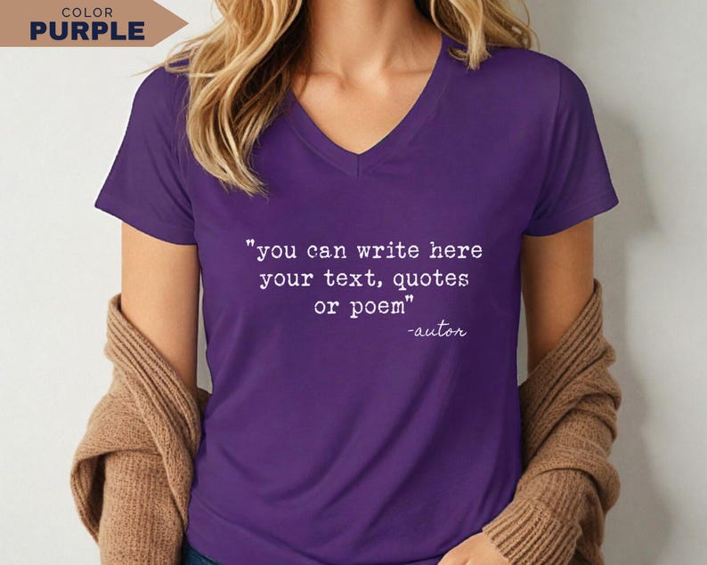May include: A purple V-neck t-shirt featuring white printed text that reads: "you can write here your text, quotes or poem" followed by "-autor". The shirt has short sleeves and is worn with a tan cardigan draped over the shoulders.