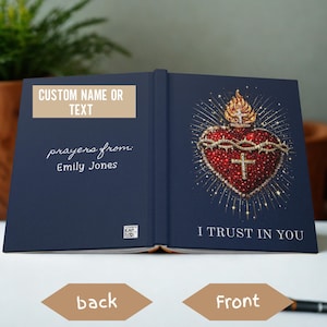 May include: A navy blue book with gold accents. The front cover features a detailed illustration of a heart with a crown of thorns and a cross. The text "I TRUST IN YOU" is below the heart. The back cover has the text "CUSTOM NAME OR TEXT" and "prayers from: Emily Jones."