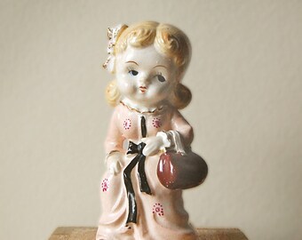 Vintage Ceramic Figurine Pink Lady Collectible Victorian Fashion Girl with Big Head in Dress with Bows and Gold Edging.