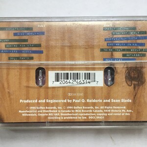 May include: A cassette tape with a brown woodgrain background. The tape is labeled with the title "Credit in the Straight World" and the artist "Miss World". The track list includes "Violet", "Plump", "Asking for It", "Jennifers Body", "Doll Parts", "Softer, Softest", "She Walks on Me", "I Think That I Would Die", "Gutless", and "Rock Star".