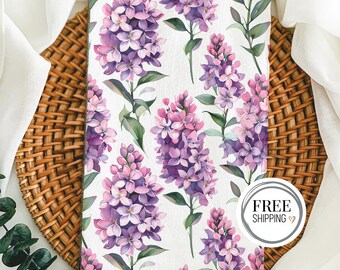 May include: A white background with a repeating pattern of purple and pink lilac flowers. The flowers are watercolor illustrations and have green stems and leaves. The text "FREE SHIPPING" is in a circle at the bottom right corner of the image.