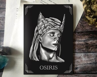 May include: A black and white art print featuring a grayscale illustration of Osiris, an ancient Egyptian deity, wearing a detailed crown. The word "OSIRIS" is printed in white at the bottom. The print is surrounded by decorative lines.