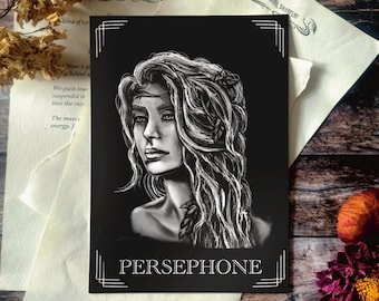 May include: Black and white art print featuring a portrait of Persephone. The artwork depicts a woman with flowing hair and a detailed facial expression. The print includes the name "PERSEPHONE" in a decorative font. The background is black.