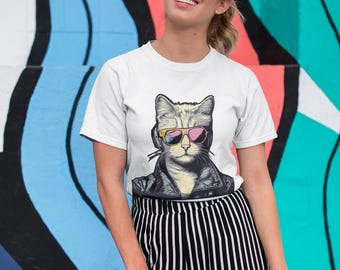 May include: White t-shirt with a graphic of a cat wearing sunglasses and a leather jacket. The cat has pink and yellow sunglasses.