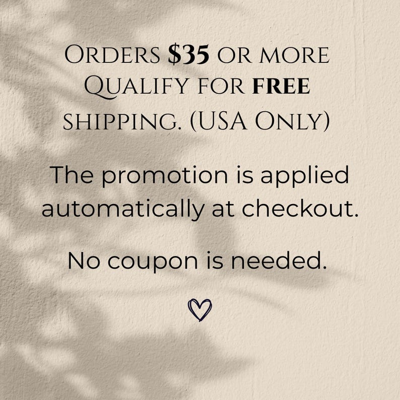 May include: Text on a beige background states "ORDERS &pound;35 OR MORE QUALIFY FOR FREE SHIPPING. (USA ONLY)". Further text explains the promotion is applied automatically at checkout, and no coupon is needed. A small heart is at the bottom.