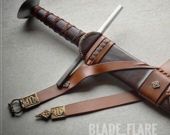 May include: A brown leather scabbard with intricate gold detailing and a sword with a silver blade and a brown leather wrapped handle. The scabbard is attached to a brown leather belt with a metal buckle. The text "BLADE_FLARE" is visible in the lower center of the image.
