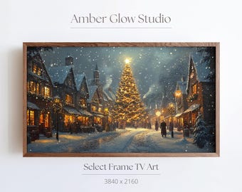 May include: A snowy Christmas scene with a large, illuminated Christmas tree in the center of a cobblestone street.  The street is lined with quaint, snow-covered buildings.  The image is framed in a dark wood frame.  Select Frame TV Art 3840 x 2160