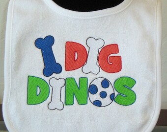 Embroidered dinosaur baby bib. Gifts for baby. Baby shower gift. Baby boy bib. Gender neutral baby bib. Bib saying "I dig dinos" KBD20148