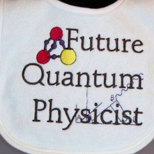 May include: White baby bib with the embroidered text "Future Quantum Physicist." The bib features a colorful graphic of atoms and scientific symbols. The bib has a rounded shape and a soft texture.