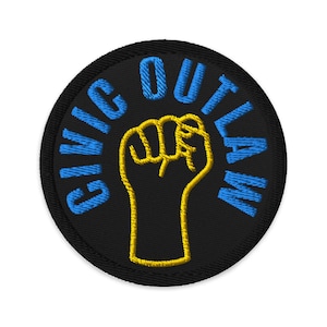 May include: Embroidered patch with the words "CIVIC OUTLAW" in blue, encircling a yellow fist on a black background. The patch is round and has a black border.