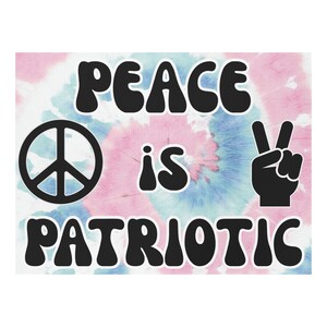 May include: A canvas featuring a tie-dye design in pink and blue. The words "PEACE is PATRIOTIC" are in a bold, black, retro font. A peace symbol and a hand making the peace sign are also in black.