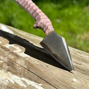 Hand forged two layer edc knife with black leather pancake sheath. Chisel grind with 1095 edge steel, brut de forge finish on backside