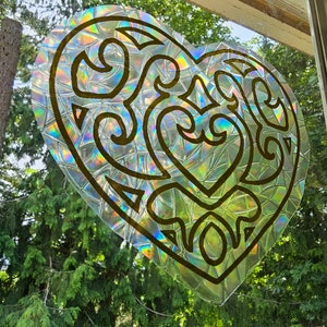 Adhesivo decorativo para ventana con forma de contenedor en forma de corazón.