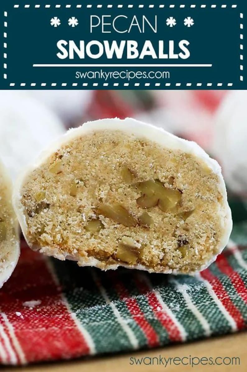 May include: A close-up of a pecan snowball cookie cut in half, revealing the pecan pieces inside. The cookie is covered in white icing and is sitting on a red and green striped napkin. The text "PECAN SNOWBALLS" is displayed above the cookie.
