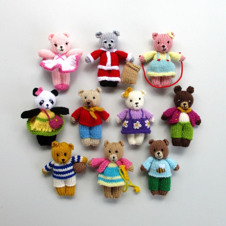 May include: A collection of ten knitted teddy bears in various colors and designs. The bears are all small and have different facial expressions. Some of the bears are wearing clothes, while others are not.
