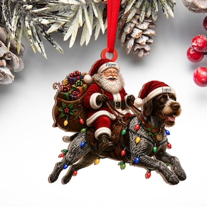 May include: A flat Christmas ornament featuring Santa Claus riding a wirehaired pointing griffon dog. Santa wears a red suit with a hat labeled Name, and the dog wears a red hat labeled Luna. A sack of gifts and colorful string lights are included.