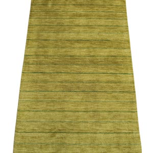 May include: A rectangular area rug featuring a textured, chartreuse green surface with a series of thin, horizontal dark green lines spaced evenly across the entire length of the piece, creating a subtle striped pattern on the flat pile.